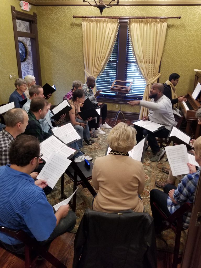 A concert underway in the decorated parlor of the Blind Boone Home